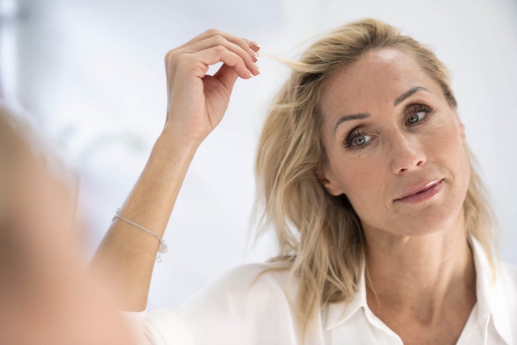 A woman pulls her hair